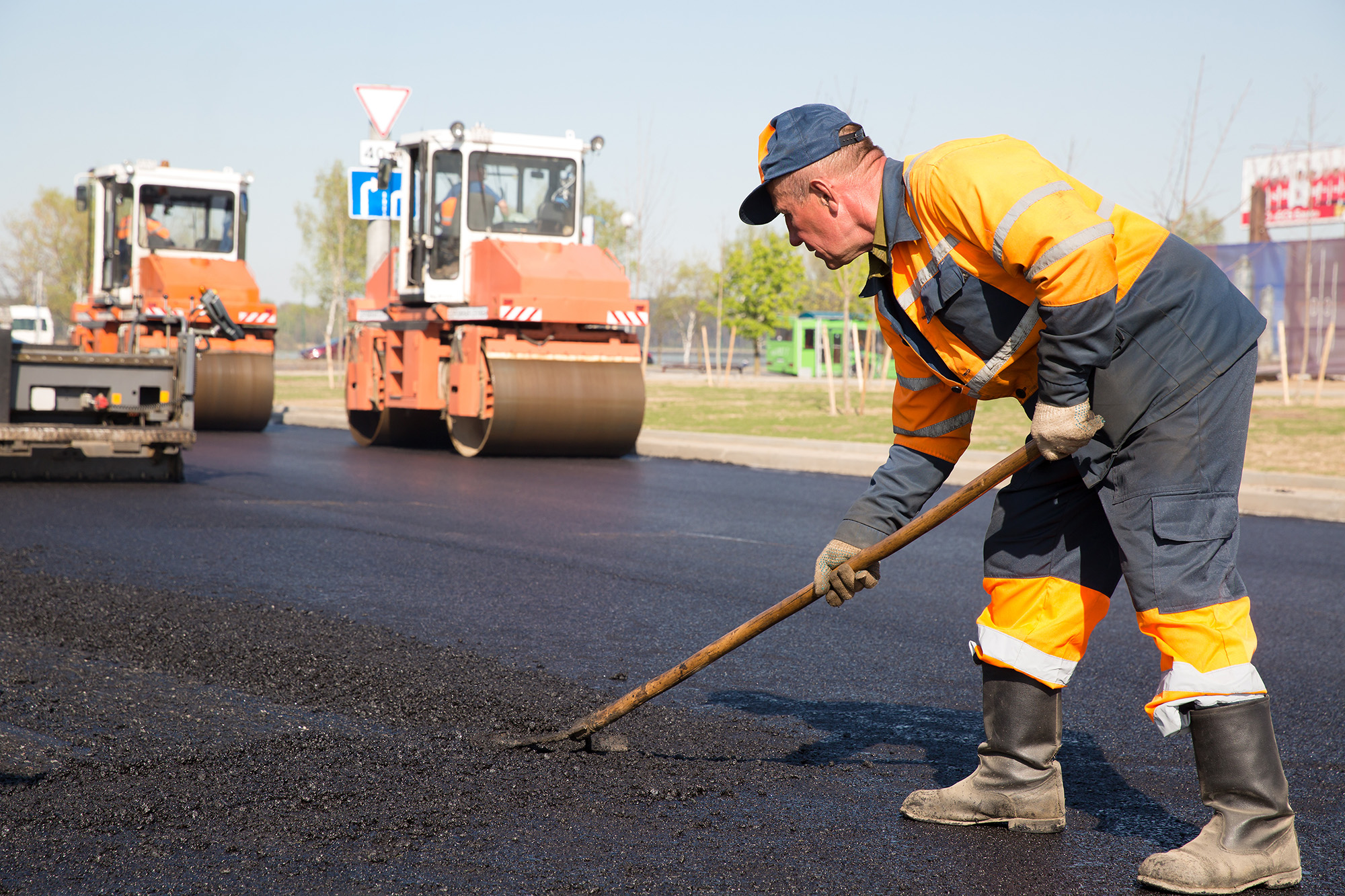 Construction worker laying asphalt